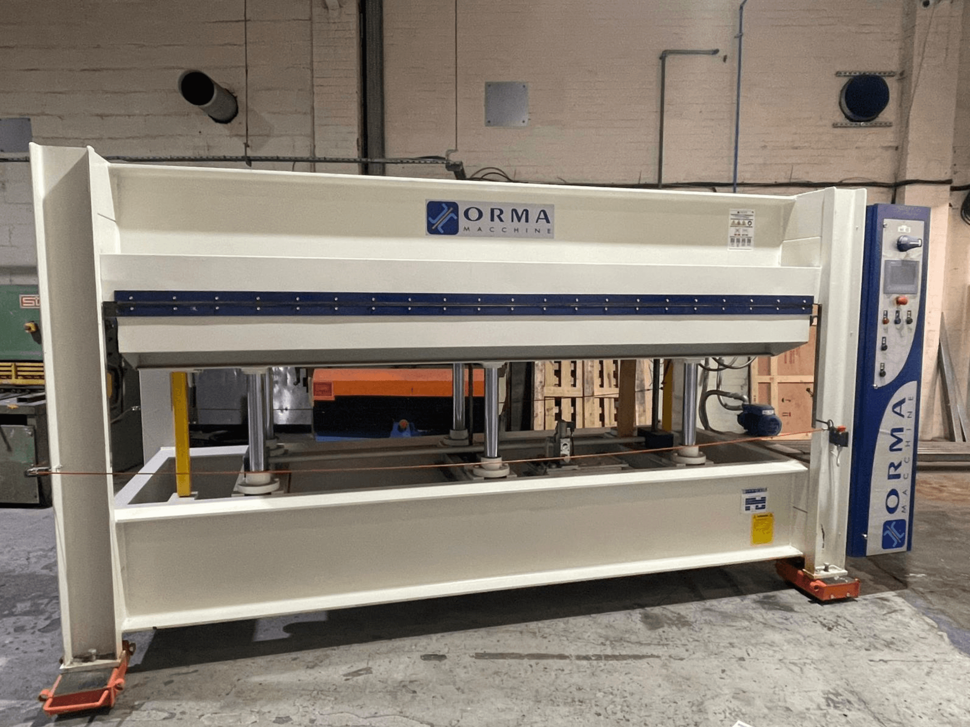 Orma Macchine hidraulinis presas iš priekio su keturiomis vertikaliomis atramomis ir valdymo pultu dešinėje pusėje.